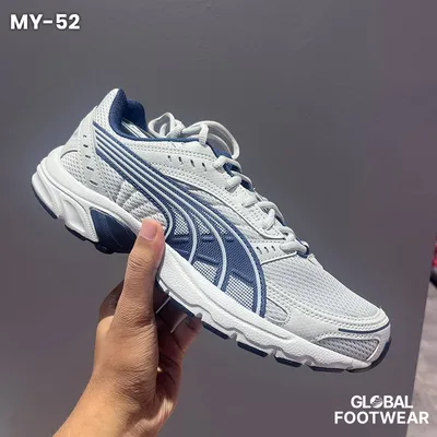 Puma Axis sneakers in a white and navy colorway