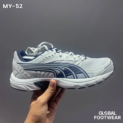 Puma Axis sneakers in a white and navy colorway